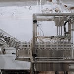 Automated beverage can packaging in a modern factory setting.