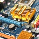 Detailed close-up of a computer motherboard showcasing various electronic components.